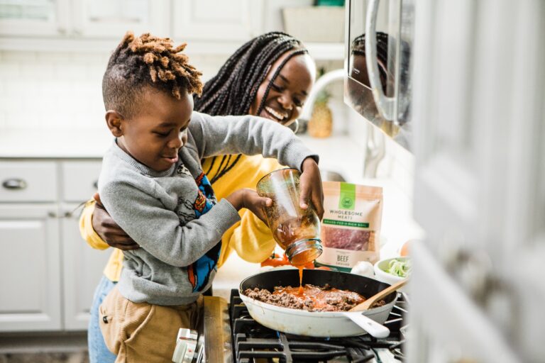 African American mom and child cooking dinner