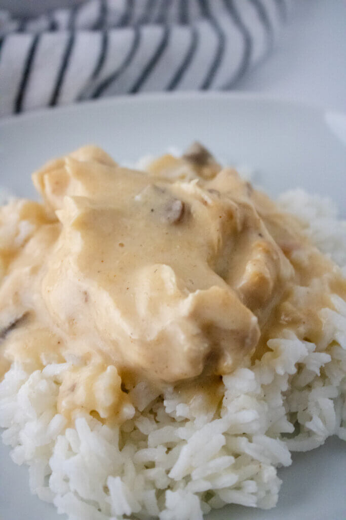 Crock Pot Smothered Chicken plated with rice